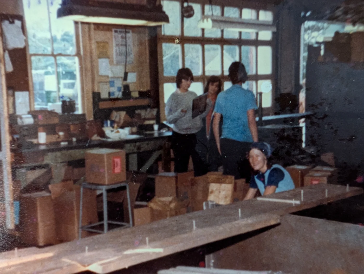 People with boxes and work tables in an archival company photograph